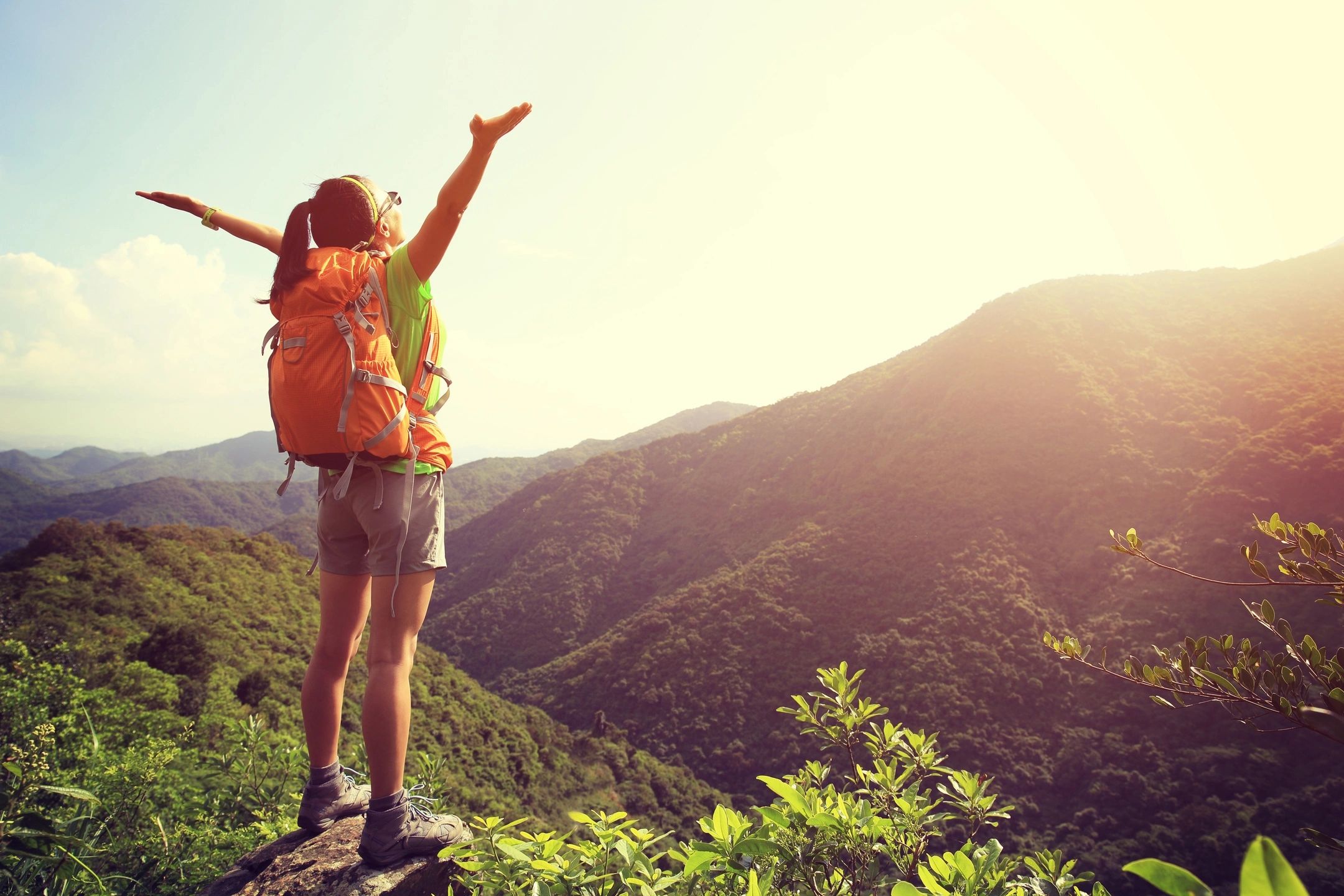 A person with a backpack on top of a mountain.