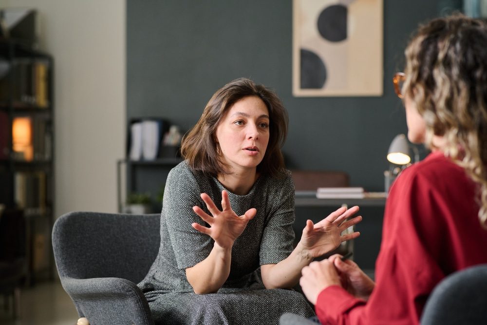 Find Your Inner Strength: Therapy in St. Thomas. Engaged in deeply meaningful discussion during a therapy session in a cozy and comfortable office setting involving intense hand gestures emphasizing important points.