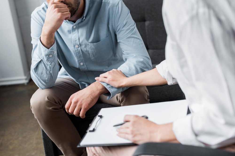 Grief Counselling. cropped shot of depressed adult man on psychologist therapy session at office.