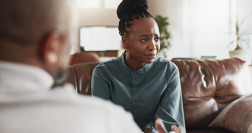Grief Counselling. Mental health, woman crying or therapist in office for grief counseling, help or advice for healing. Sad patient, depression or psychologist in practice for loss, anxiety or consultation for support.